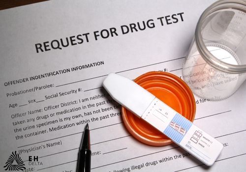 Drug test kit on top of a paper form requesting a drug test